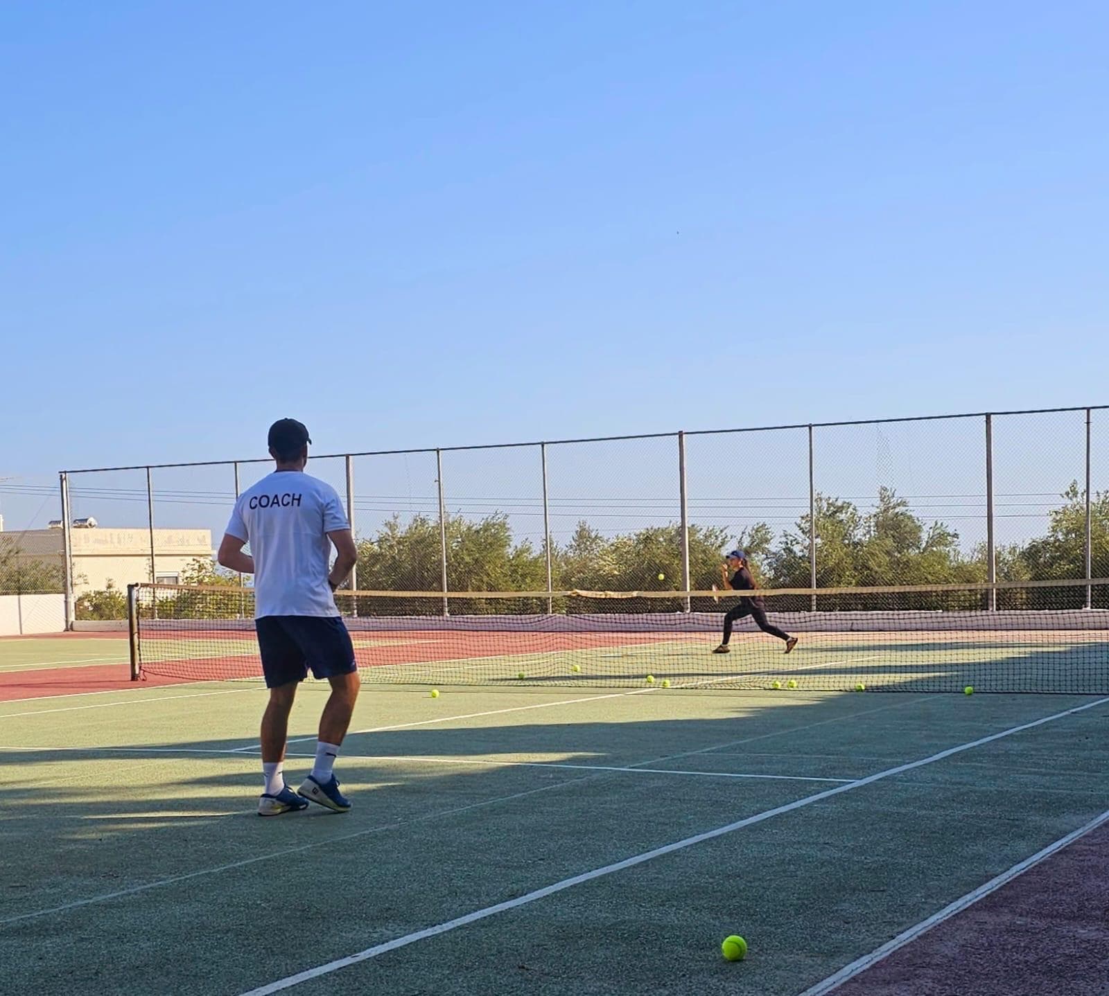 Mark feeding a crosscourt drill on court